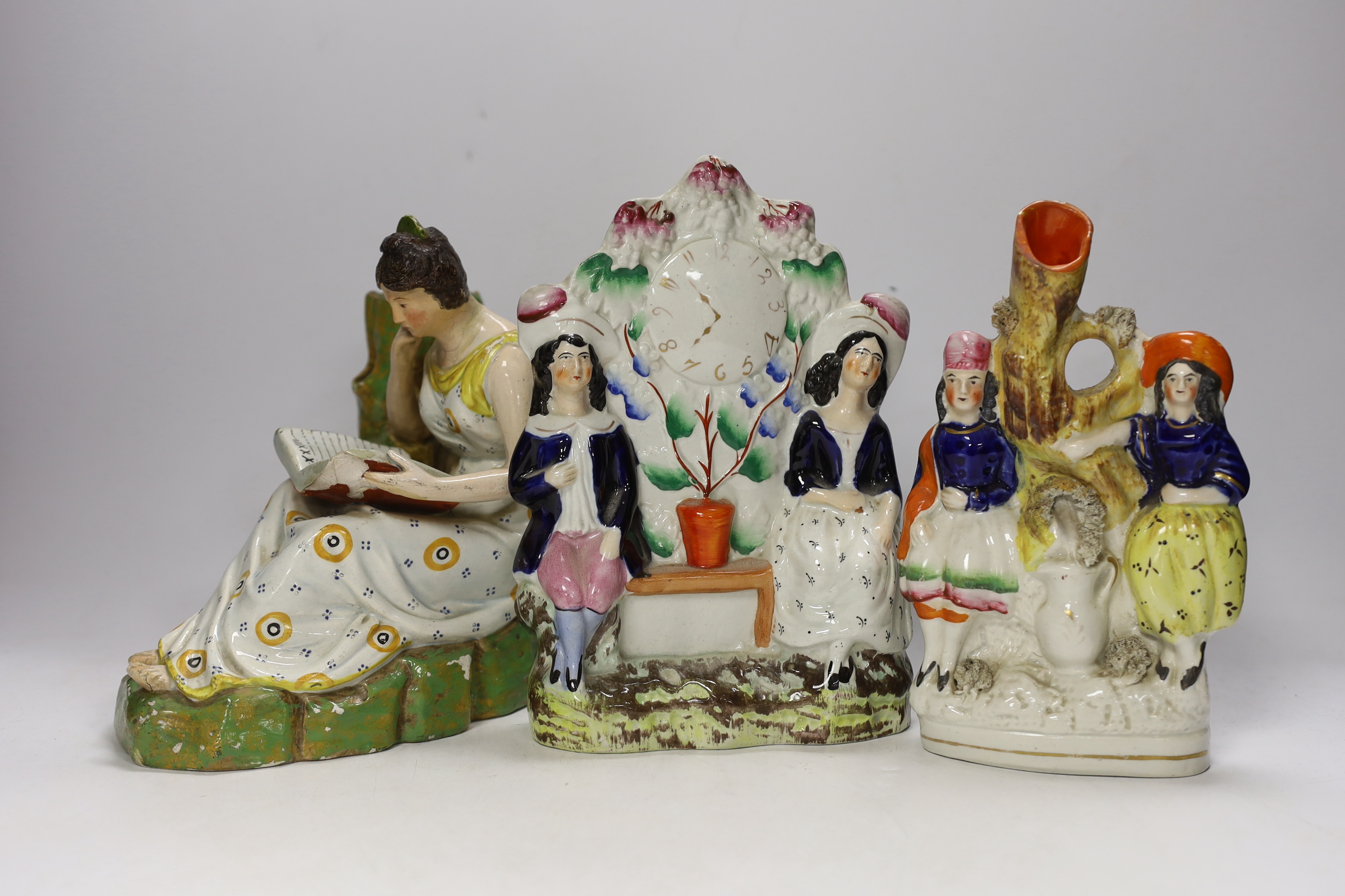 An early 19th century Staffordshire pearlware figure of a seated lady and seven mid 19th century Staffordshire pottery figures